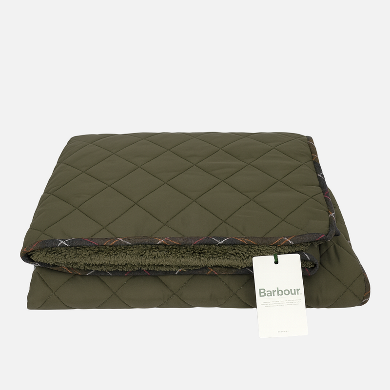 Green quilted blanket with a Barbour tag on a white background