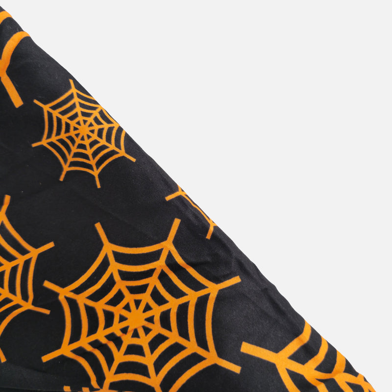 Black fabric with orange spider webs on a white background