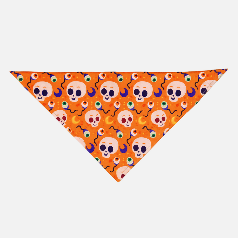 Orange triangle-shaped bandana with skull and eye pattern on a light gray background