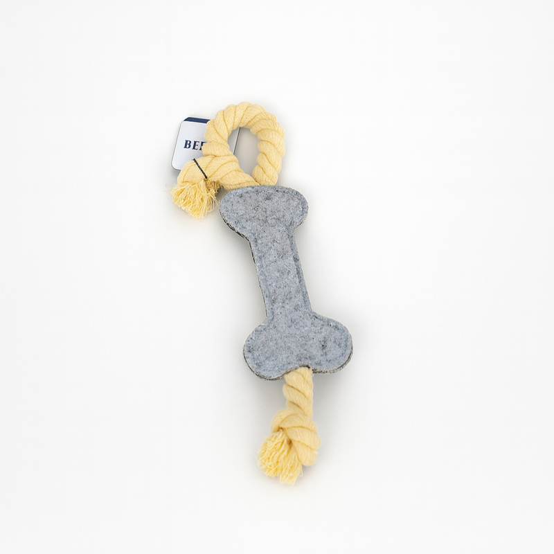 Dog toy with bone shape and yellow rope on a white background