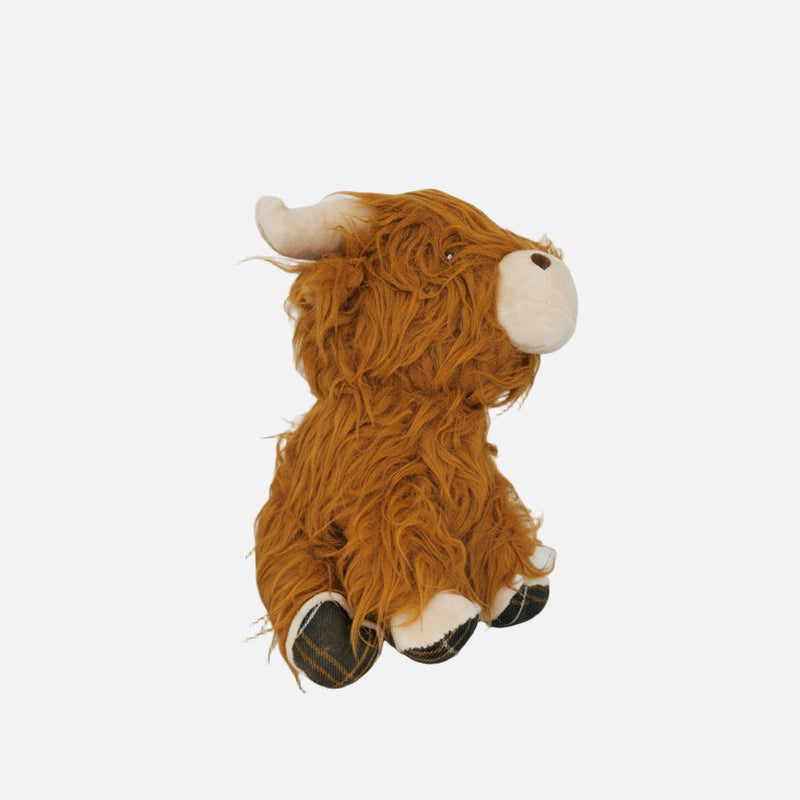 Plush toy resembling a brown cow with white accents on a light gray background