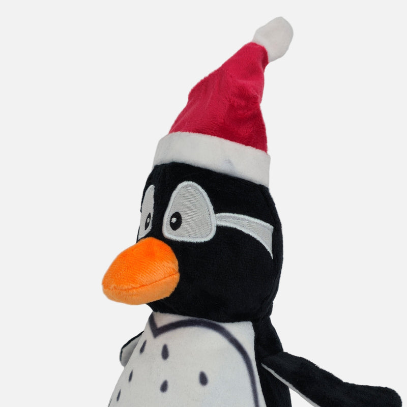 Christmas penguin plush dog toy with orange feet and a Santa hat, featuring a built-in squeaker for indoor holiday play.