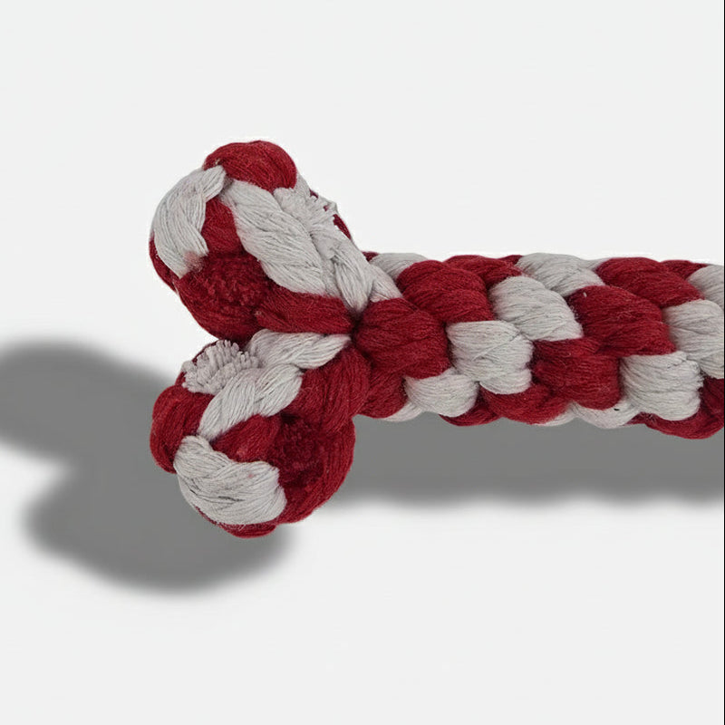 Red and white Christmas rope bone dog toy made from tightly woven cotton, designed for chewing and tug play.